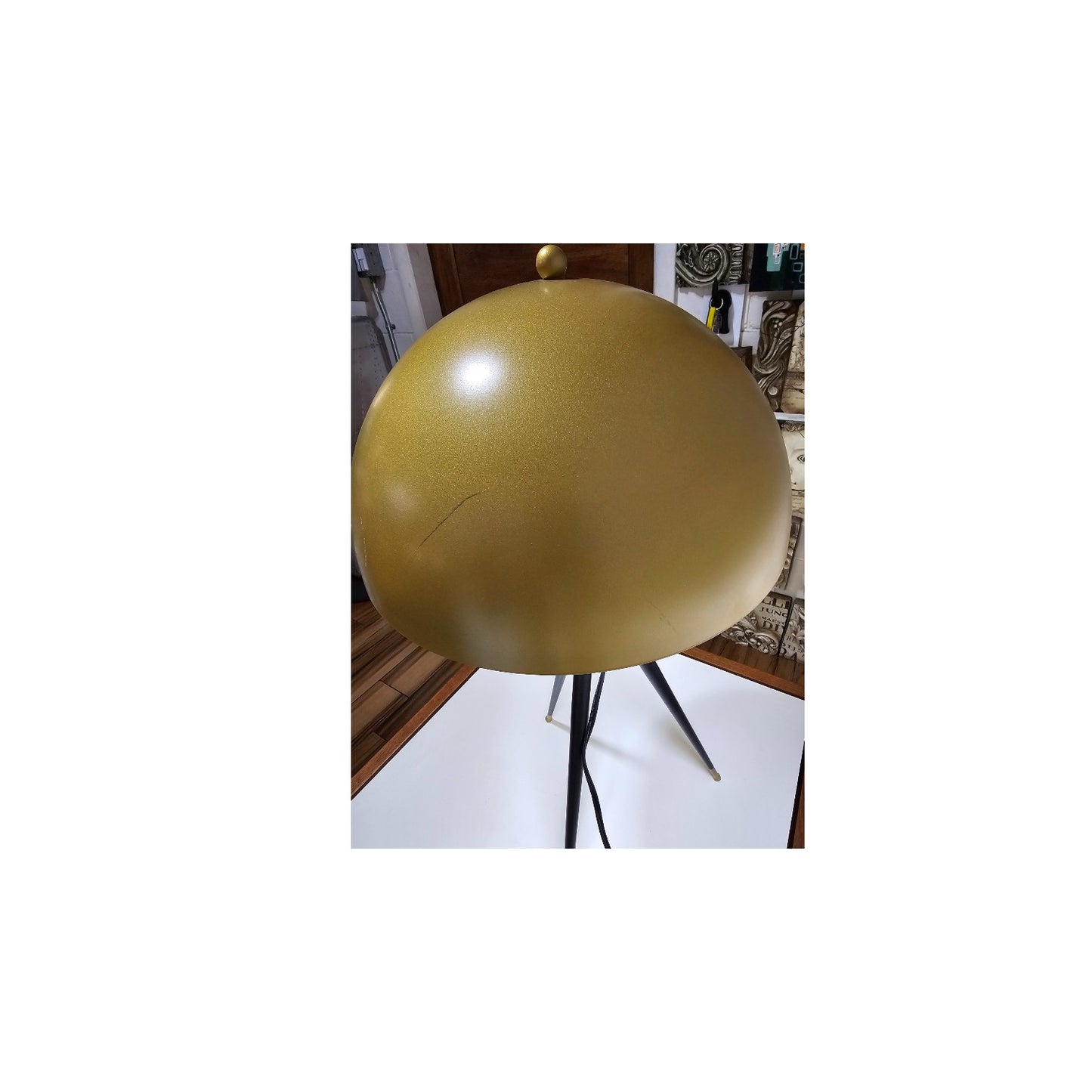 Midcentury tripod lamp, sleek lamp shade with wooden legs.
