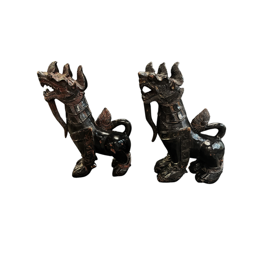 Side view of a pair of antique Chinese Foo dogs carved in wood