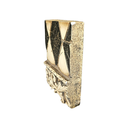 Side view of decorative wall plaque with geometric pattern on a white background