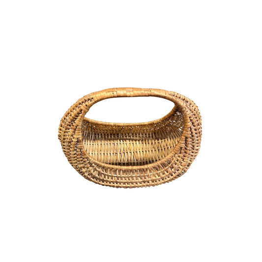 Top view of a large rattan and wicker basket with a natural vintage half-moon