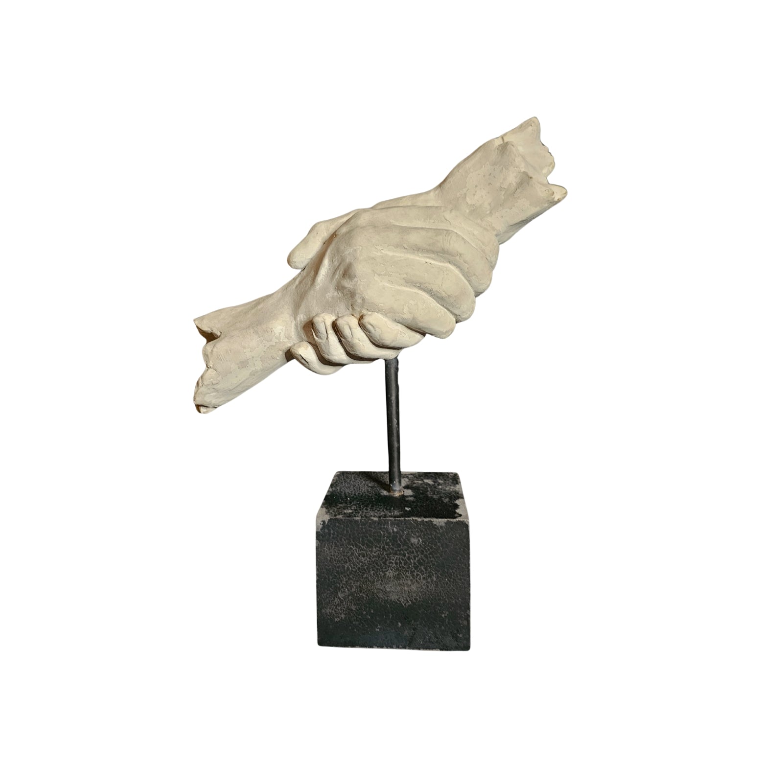 Statue of a hand holding a heart on a black square base against a white background