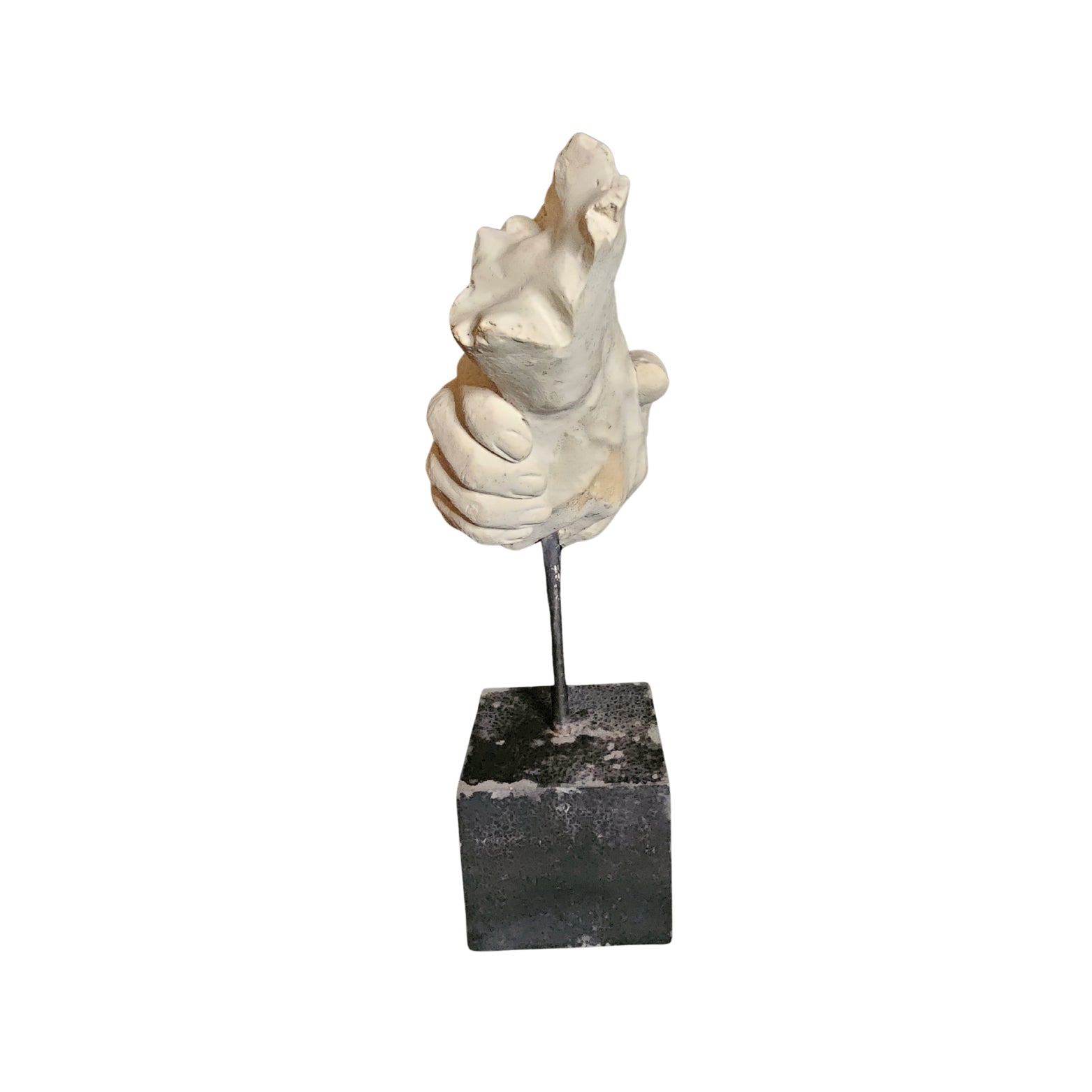 Decorative sculpture on a black square base against a white background