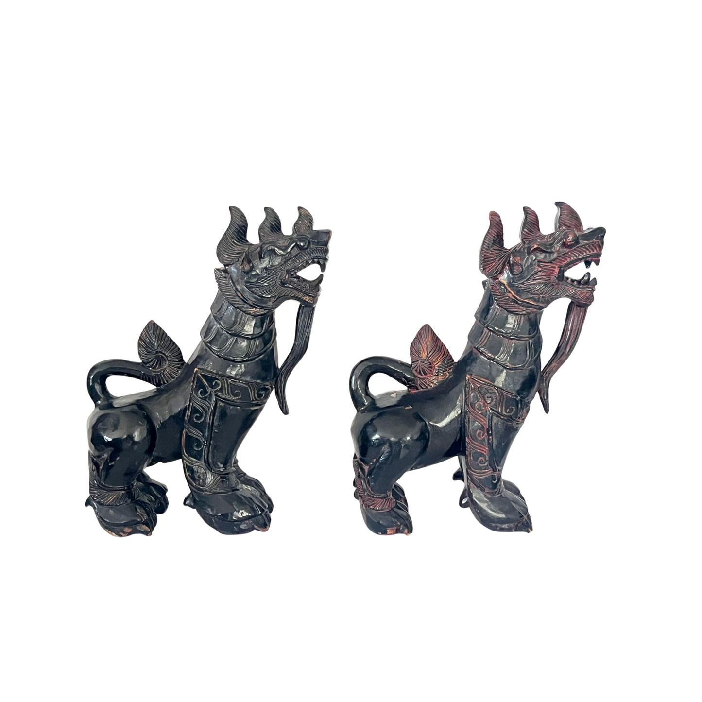 Side view of a pair of antique Chinese Foo dogs carved in wood