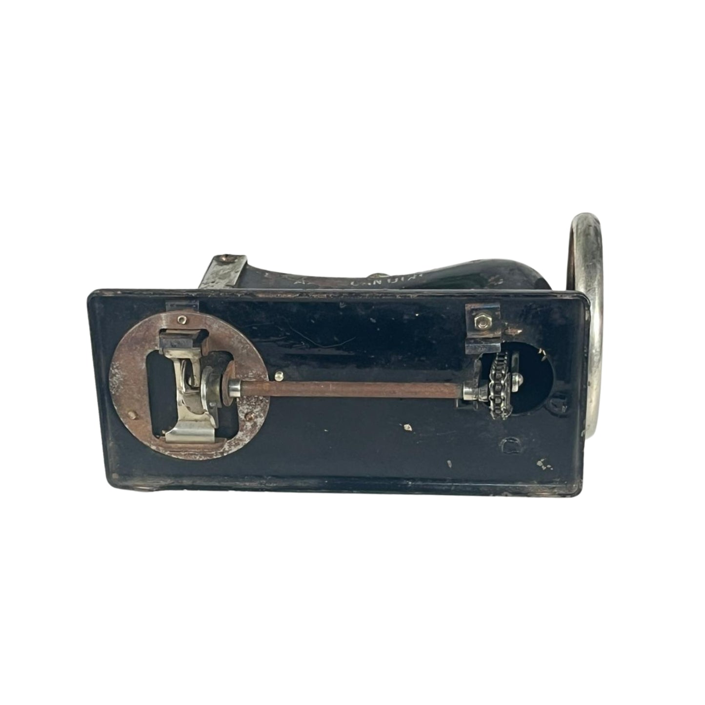 Bottom view of a vintage sewing machine on a white background