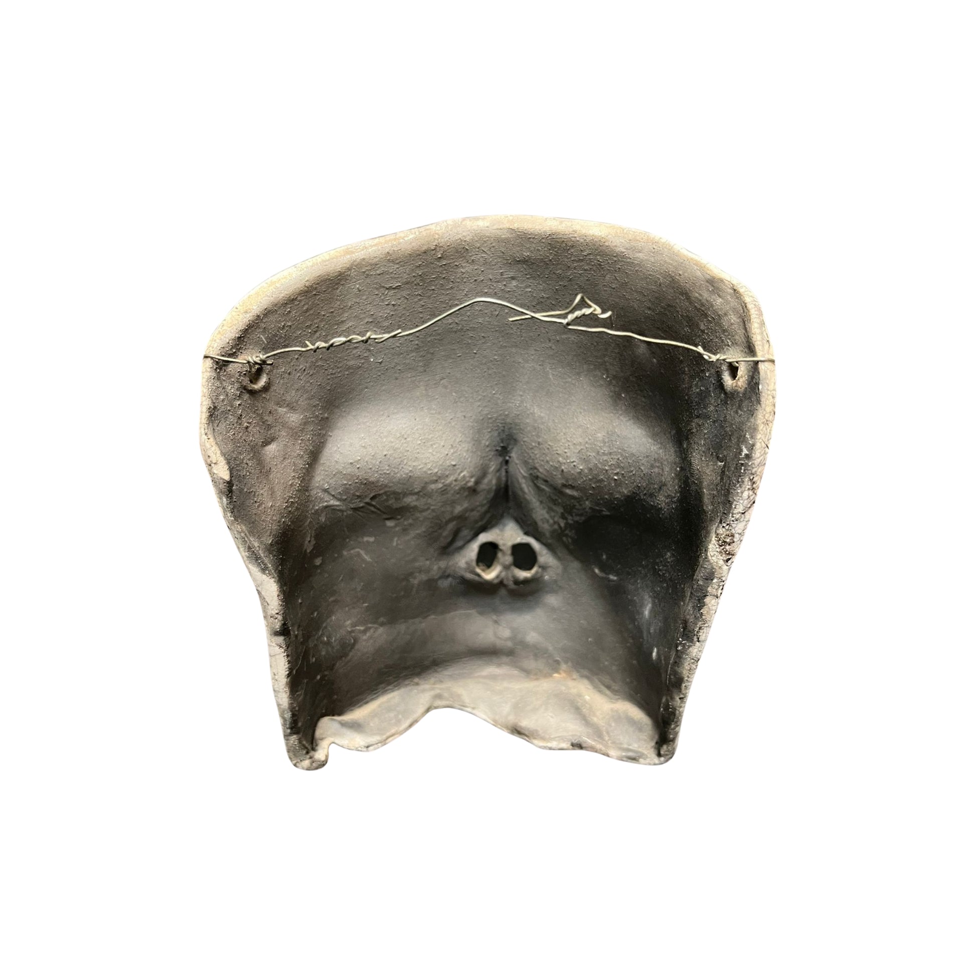 Back view of a ceramic face sculpture with teal accents on a white background