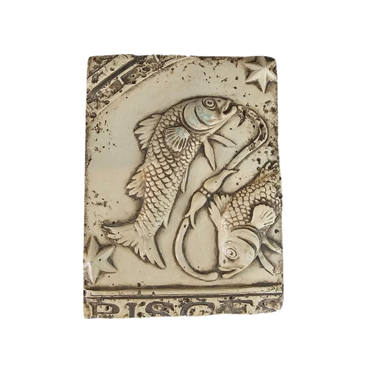 Decorative wall plaque with a fish design on a white background