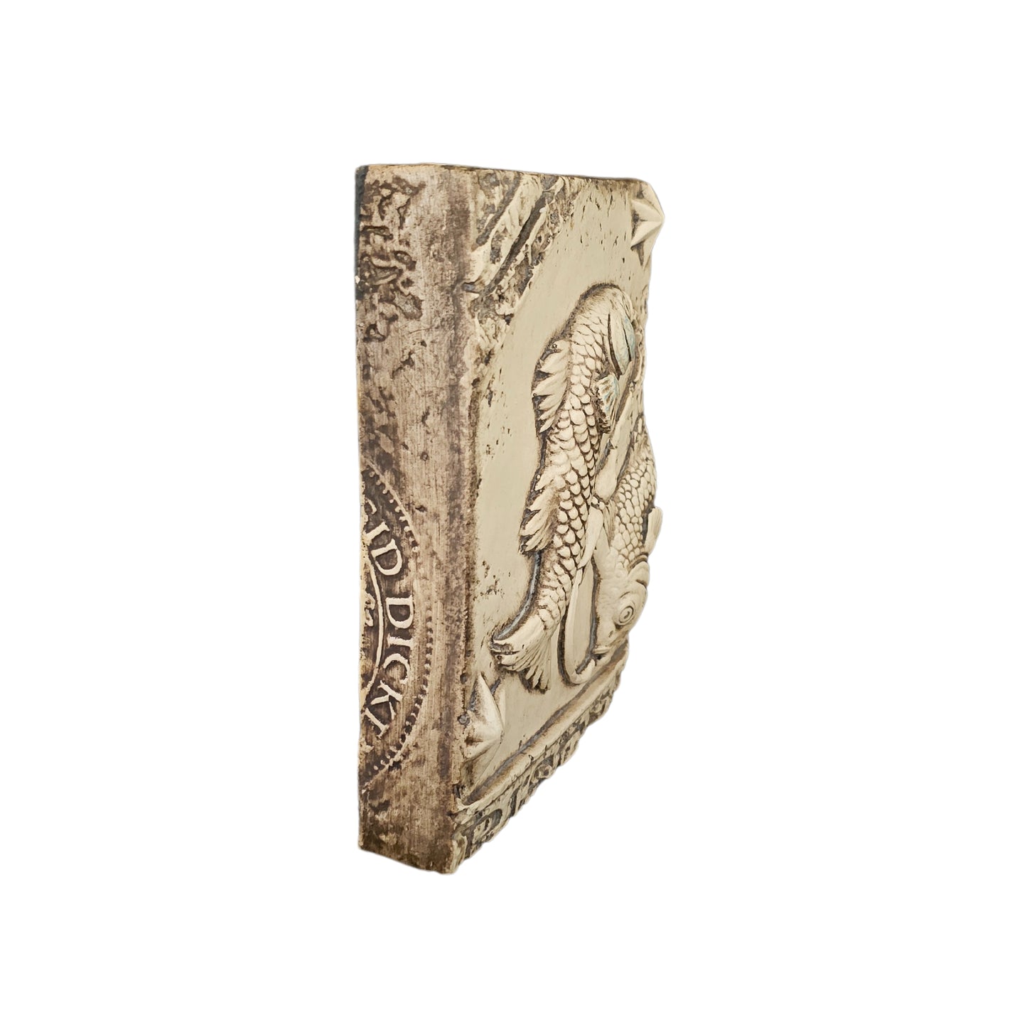 Side view of decorative wall plate with fish design on a white background