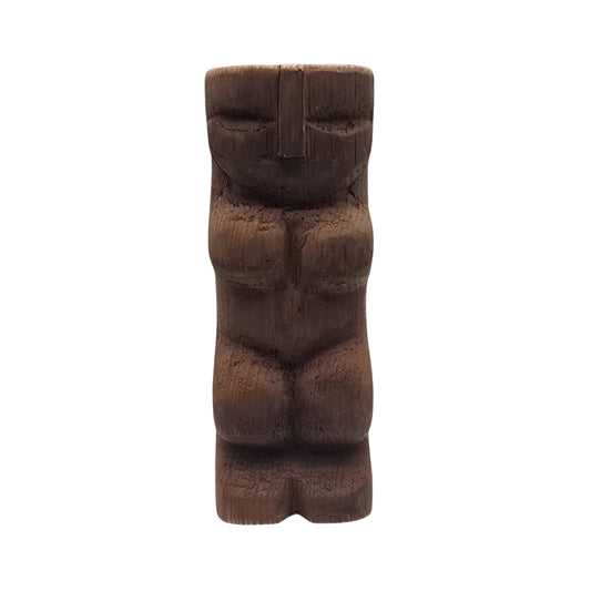 Carved wooden Hawaiian tiki sculpture on a white background