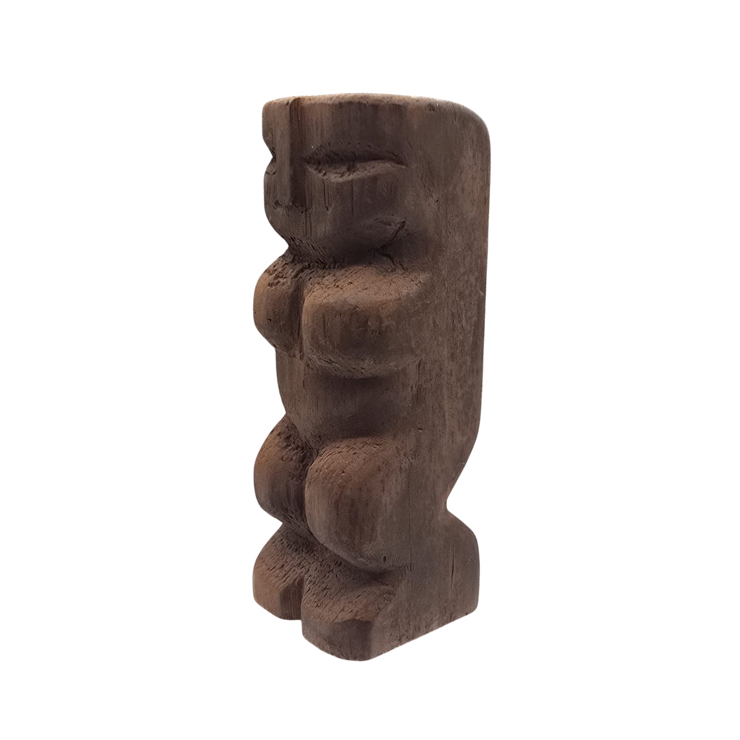 Side view of a Hawaiian wooden tiki sculpture on a white background