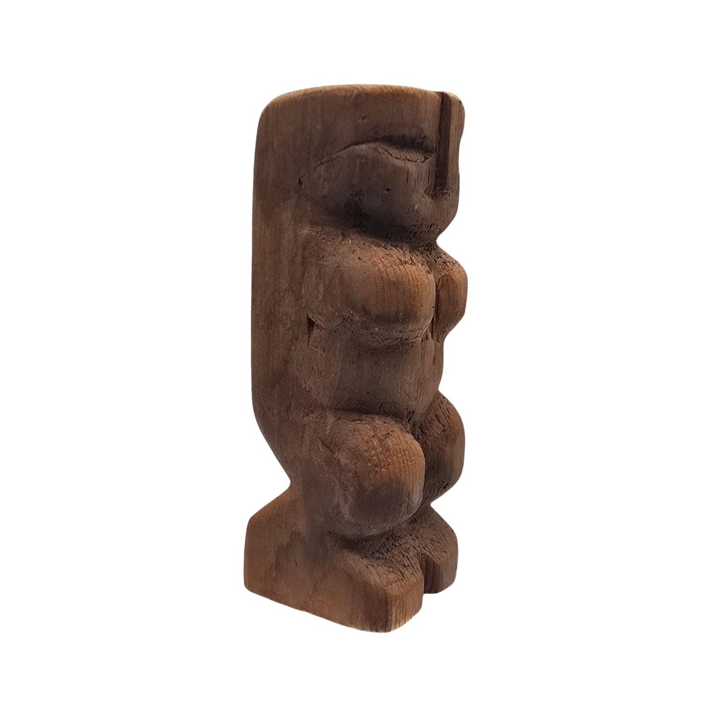 Side view of a Hawaiian wooden tiki sculpture on a white background