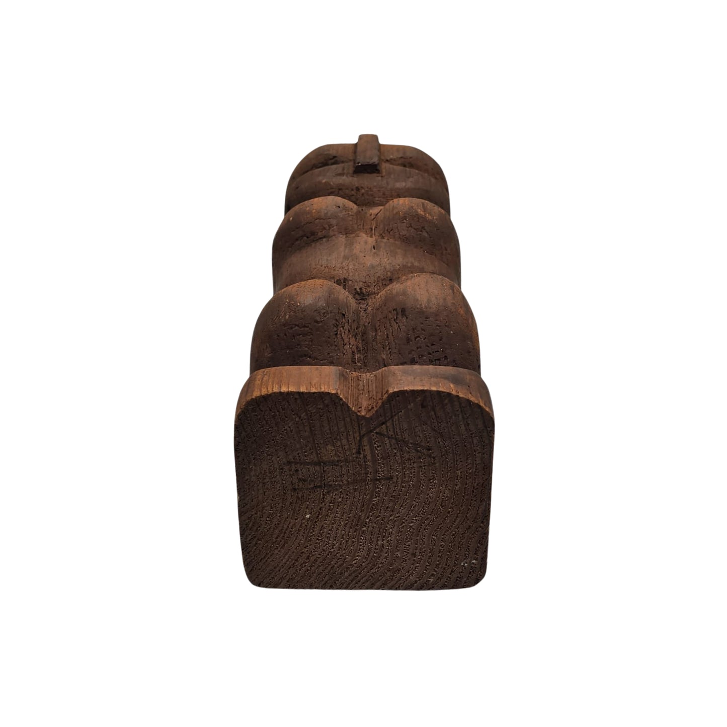 Bottom view of a Hawaiian wooden tiki sculpture on a white background