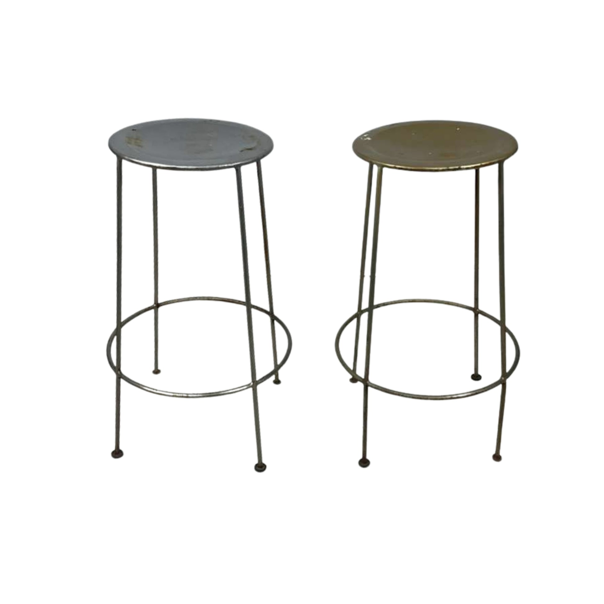 Two metal bar stools with round tops on a white background