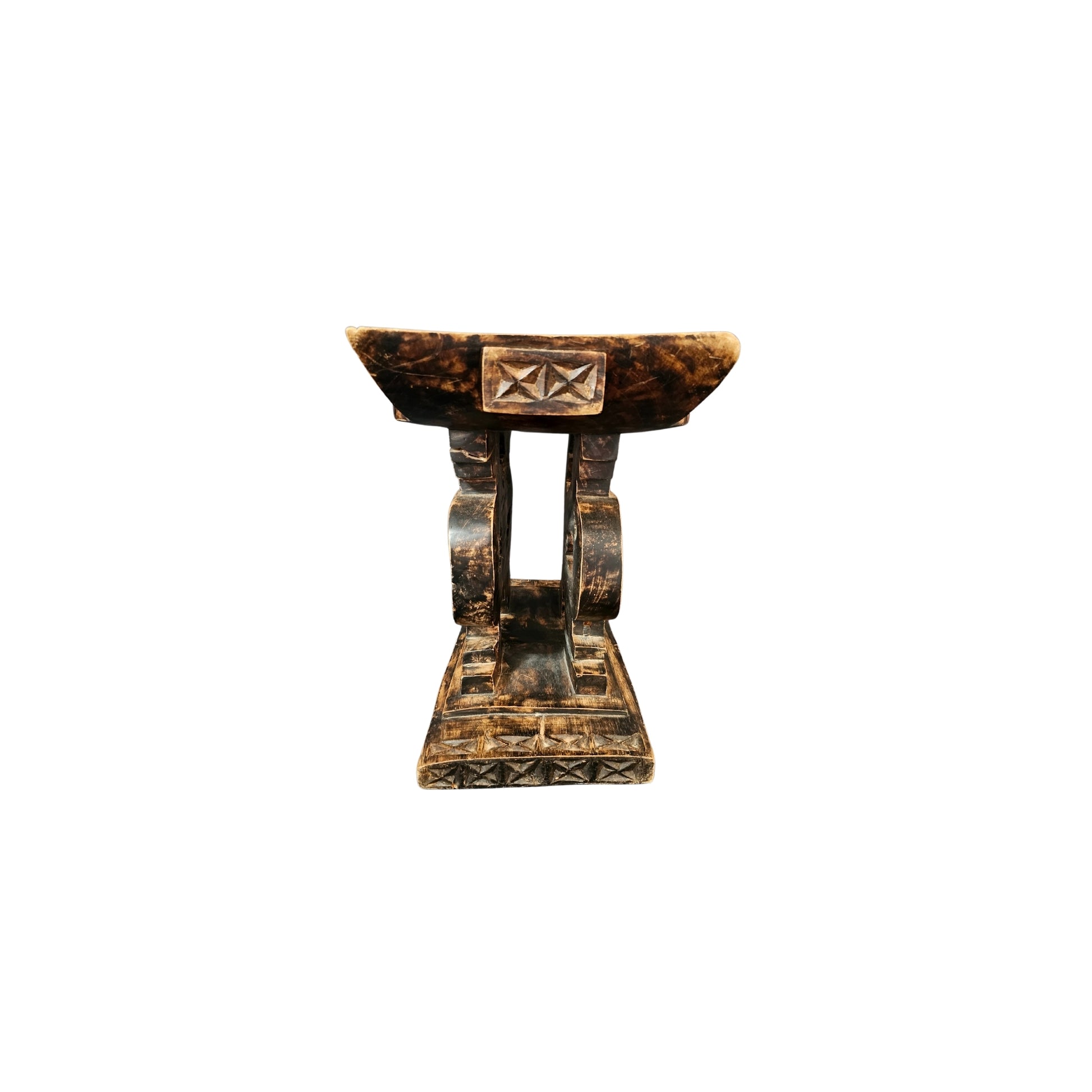 Take a trip back in time with our Vintage Carved Wood Ashanti Stool. This unique piece was crafted in Ghana during the 1950s era and showcases the rich history and culture of the African Ashanti tribe. Every groove and curve on this stool tells a story, making it a perfect addition to any home looking to embrace adventure and take a risk with their decor. Transport your space to a whole new level of boldness and style with this one-of-a-kind piece!