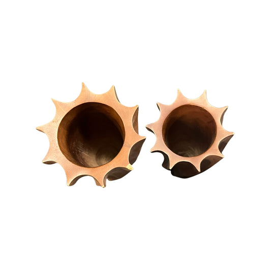 Front the top view of two wooden art glasses with a wavy design on a white background