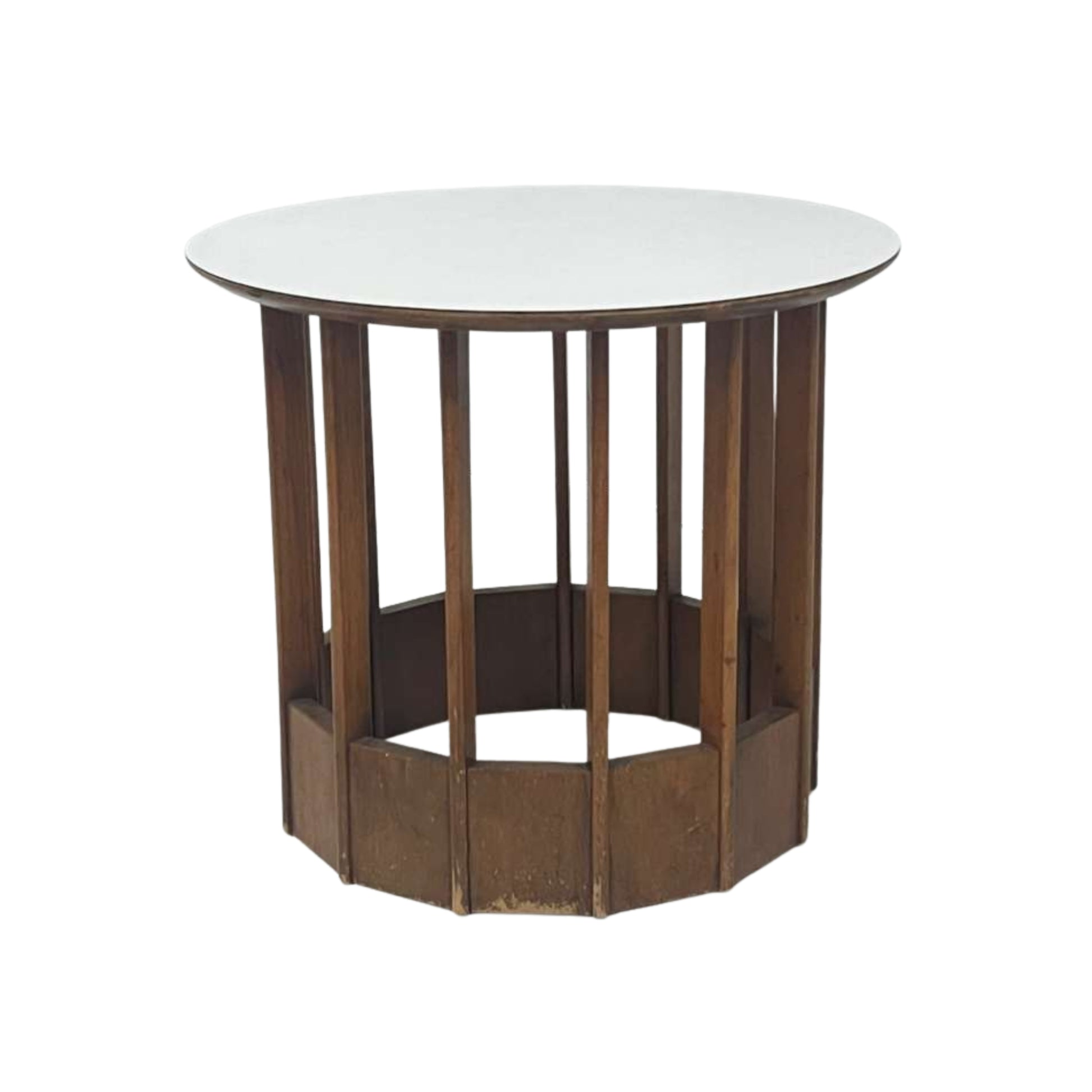 View of a rattan side table with a white top on a white background