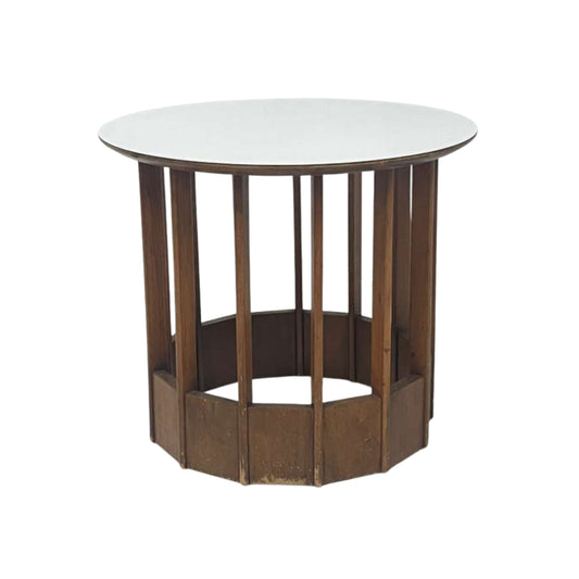 View of a rattan side table with a white top on a white background