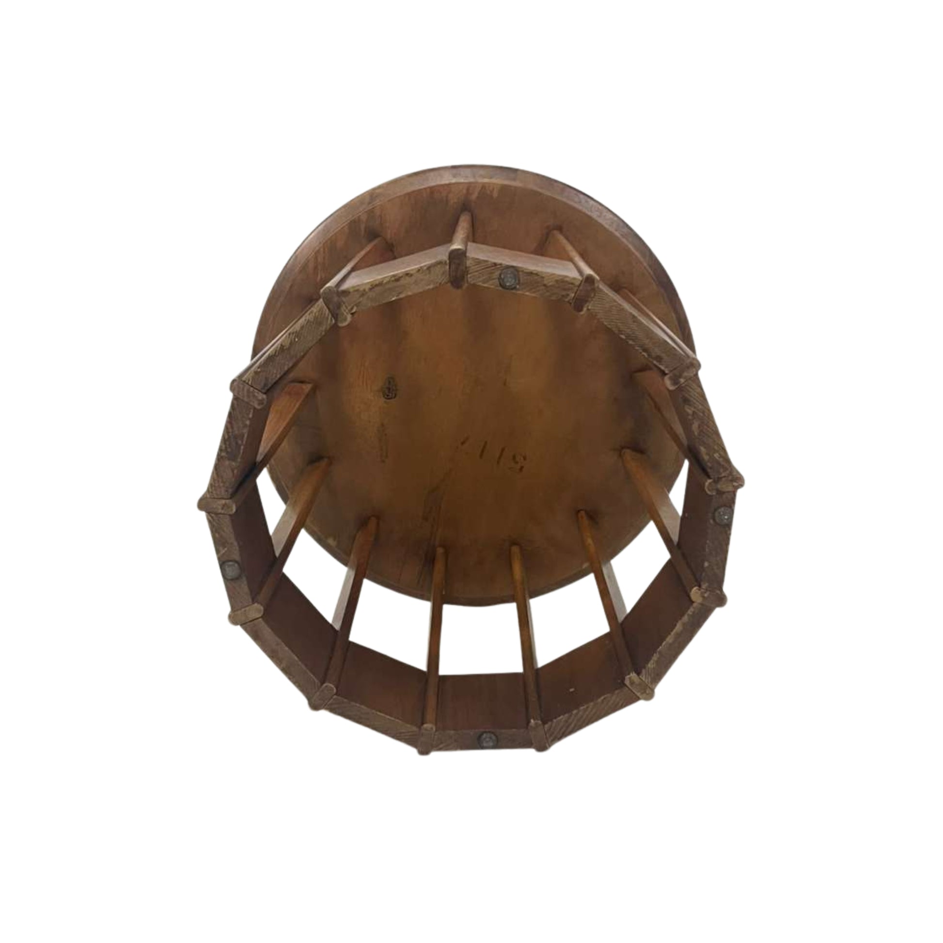 View from the bottom of a rattan side table with a white top on a white background