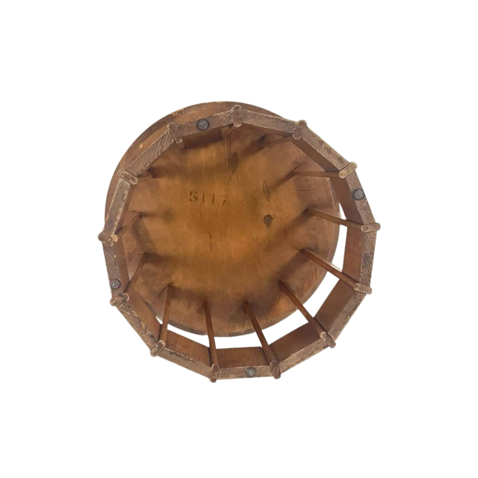 View from the bottom of a rattan side table with a white top on a white background