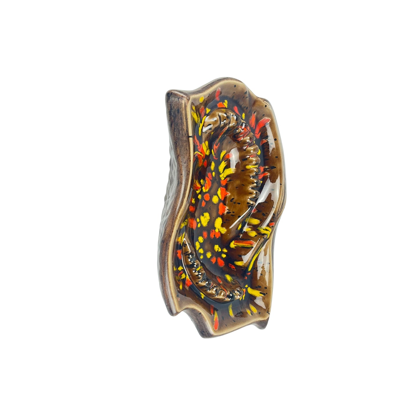 Top view of a vintage decorative ceramic ashtray with artistic design, with shades of orange, yellow, and brown on a white background