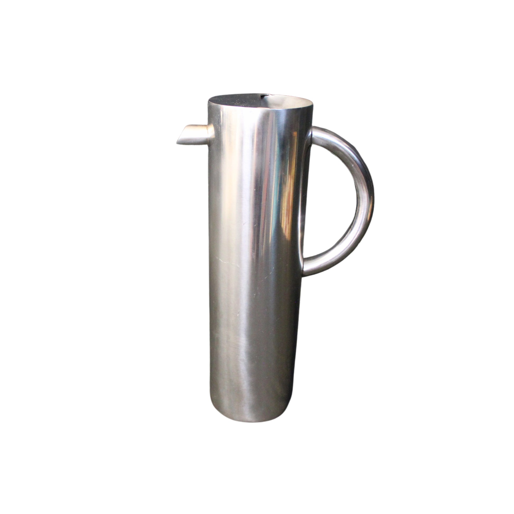Stainless steel pitcher on a white background