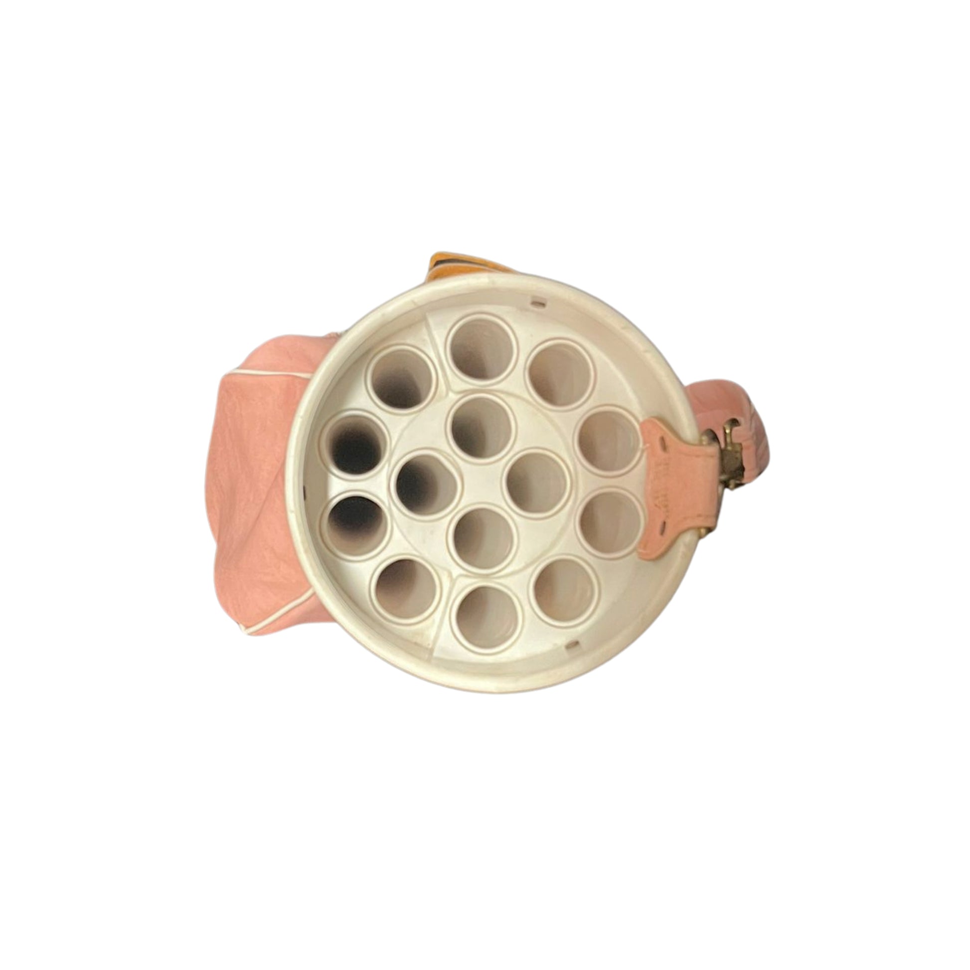Top view of a pink golf bag with a strap on a white background