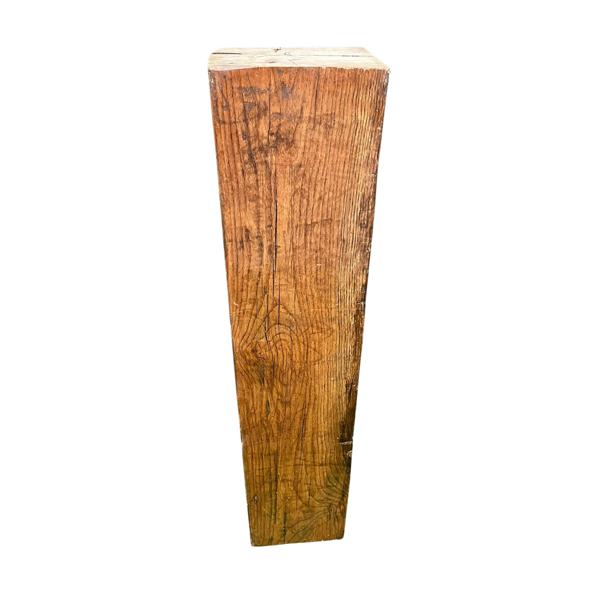Wooden pedestal with a rough, textured surface on a white background