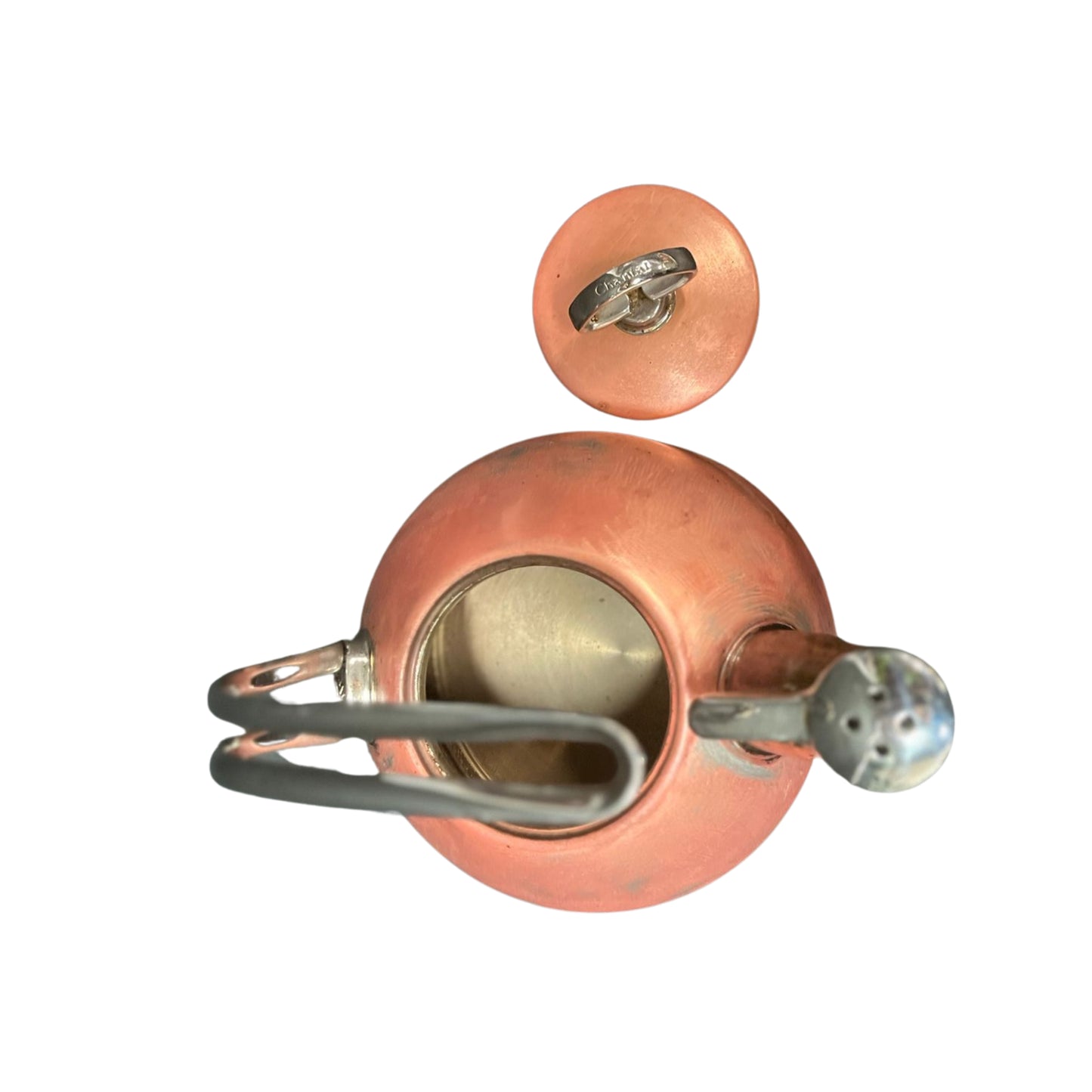 Top view of a copper kettle without a lid, with a handle and silver spout on a white background