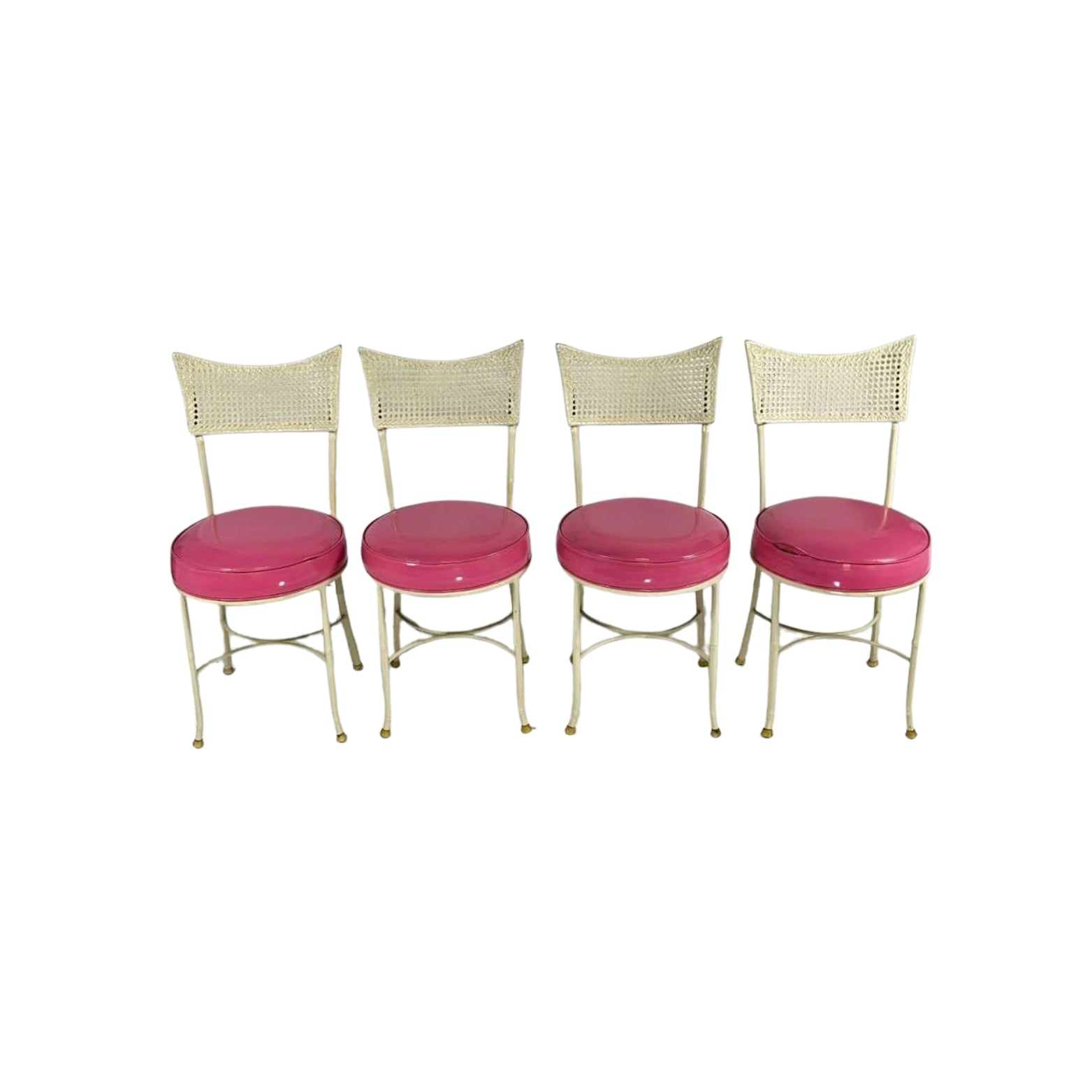 Front view of 4 iron chairs with cane and bamboo imitation in pink vegan leather on a white background