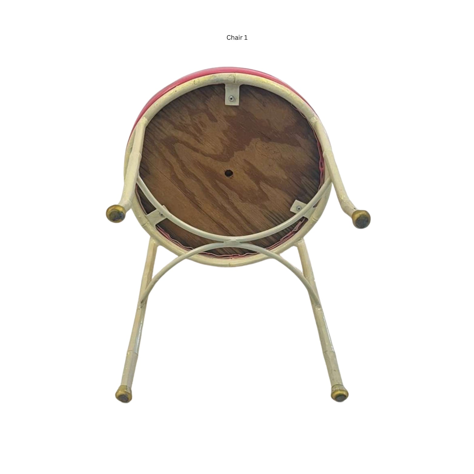 Bottom view of an iron chair with cane and bamboo imitation in pink vegan leather on a white background