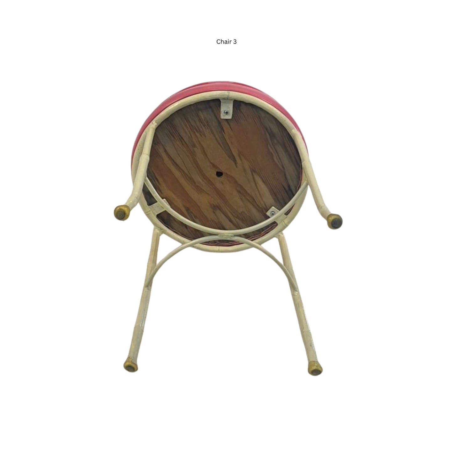 Bottom view of an iron chair with cane and bamboo imitation in pink vegan leather on a white background
