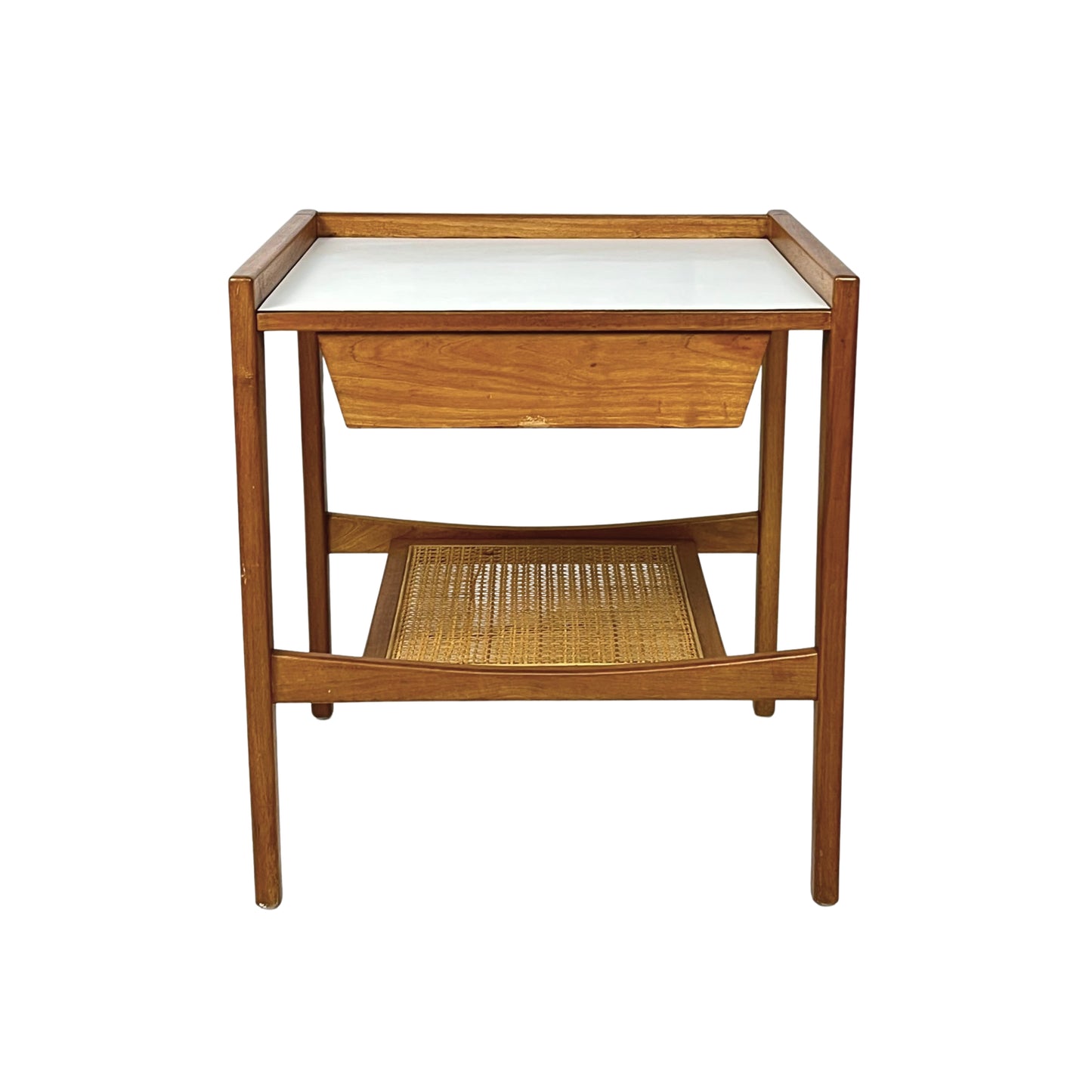 Wooden side table with a white top and wicker shelf on a white background
