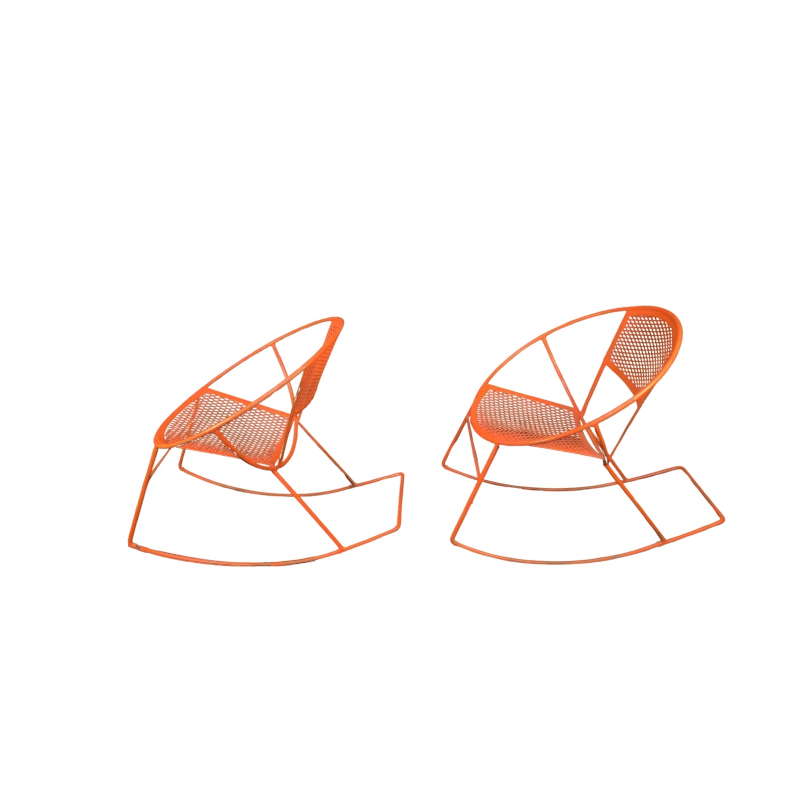 Side view of two orange wrought iron rocking chairs on a white background