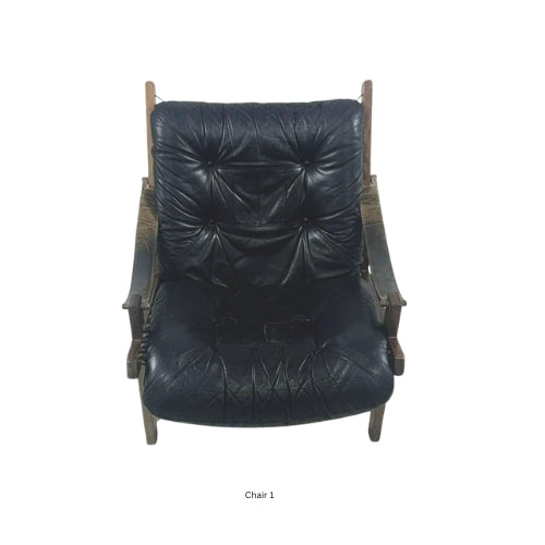 Front view of a vintage mid‑century modern lounge chair with dark tufted leather cushions and a sculpted wooden frame