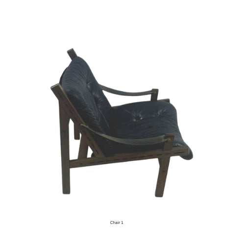 Side view of a vintage mid‑century modern lounge chair with dark tufted leather cushions and a sculpted wooden frame