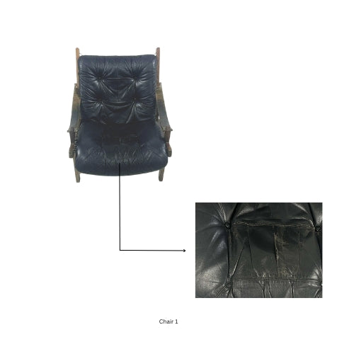 Front view of a vintage wooden lounge chair with dark tufted leather cushions, showing close‑up wear and cracking on the seat