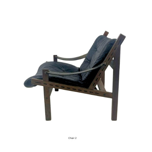 Side view of a vintage mid‑century modern lounge chair with dark tufted leather cushions and a sculpted wooden frame