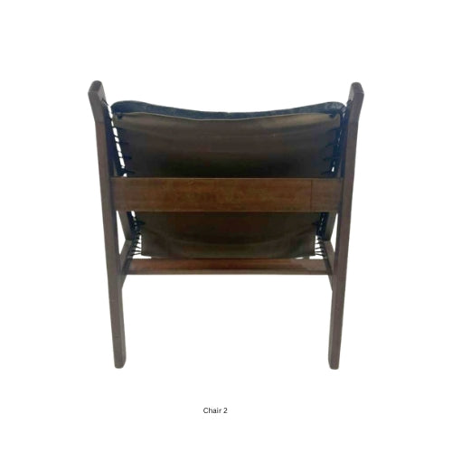 Back view of a vintage mid‑century modern lounge chair with dark tufted leather cushions and a sculpted wooden frame
