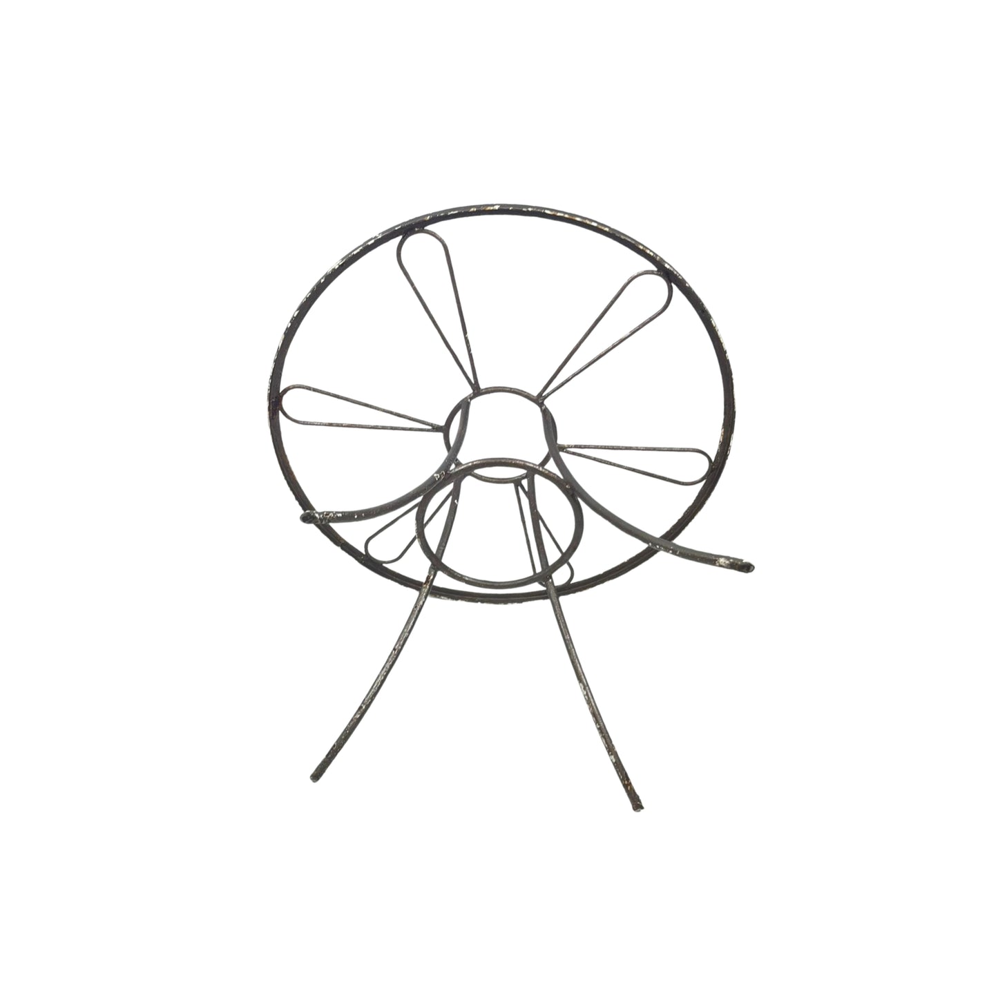 Bottom view of a round wrought iron table without the glass top on a white background