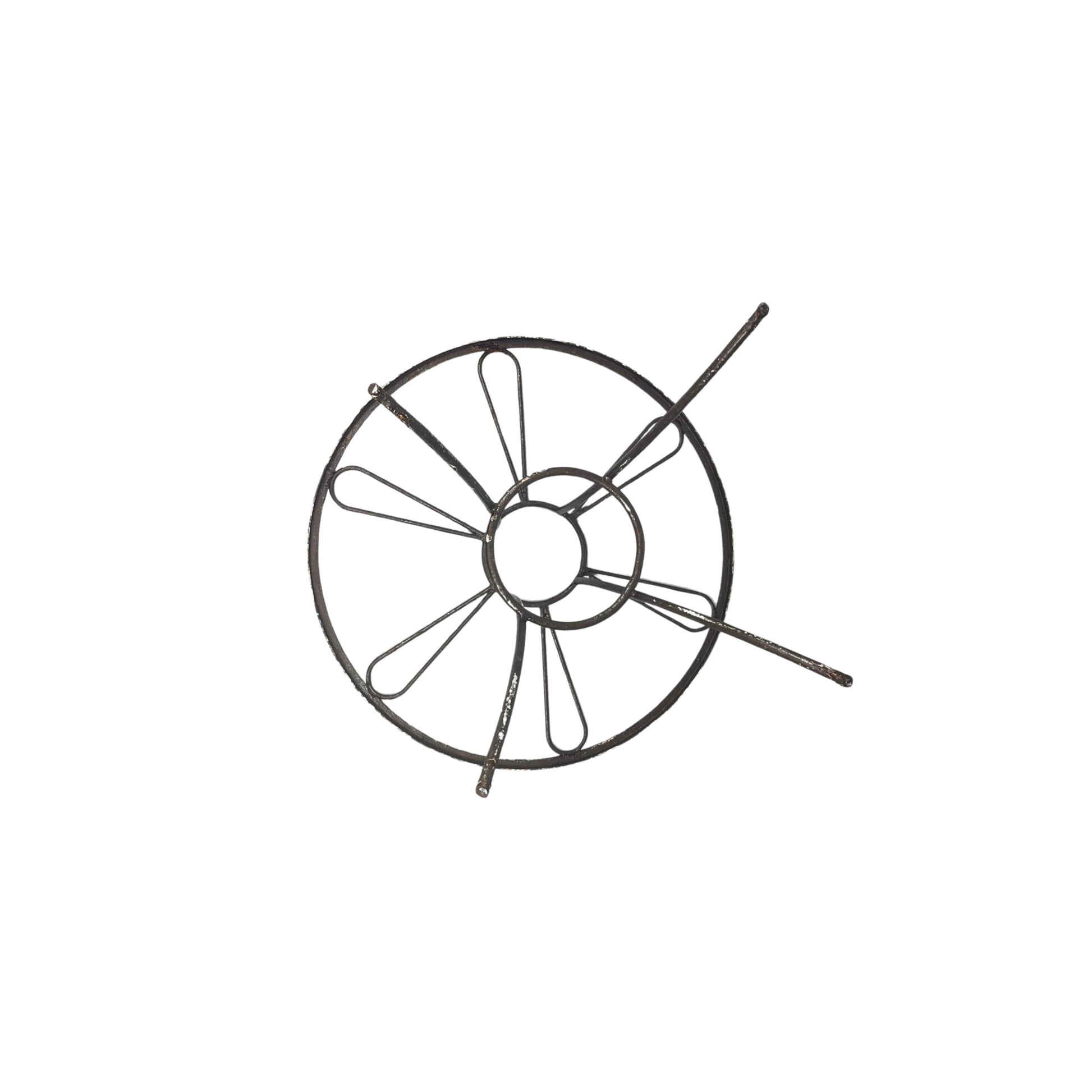 Bottom view of a round wrought iron table without the glass top on a white background