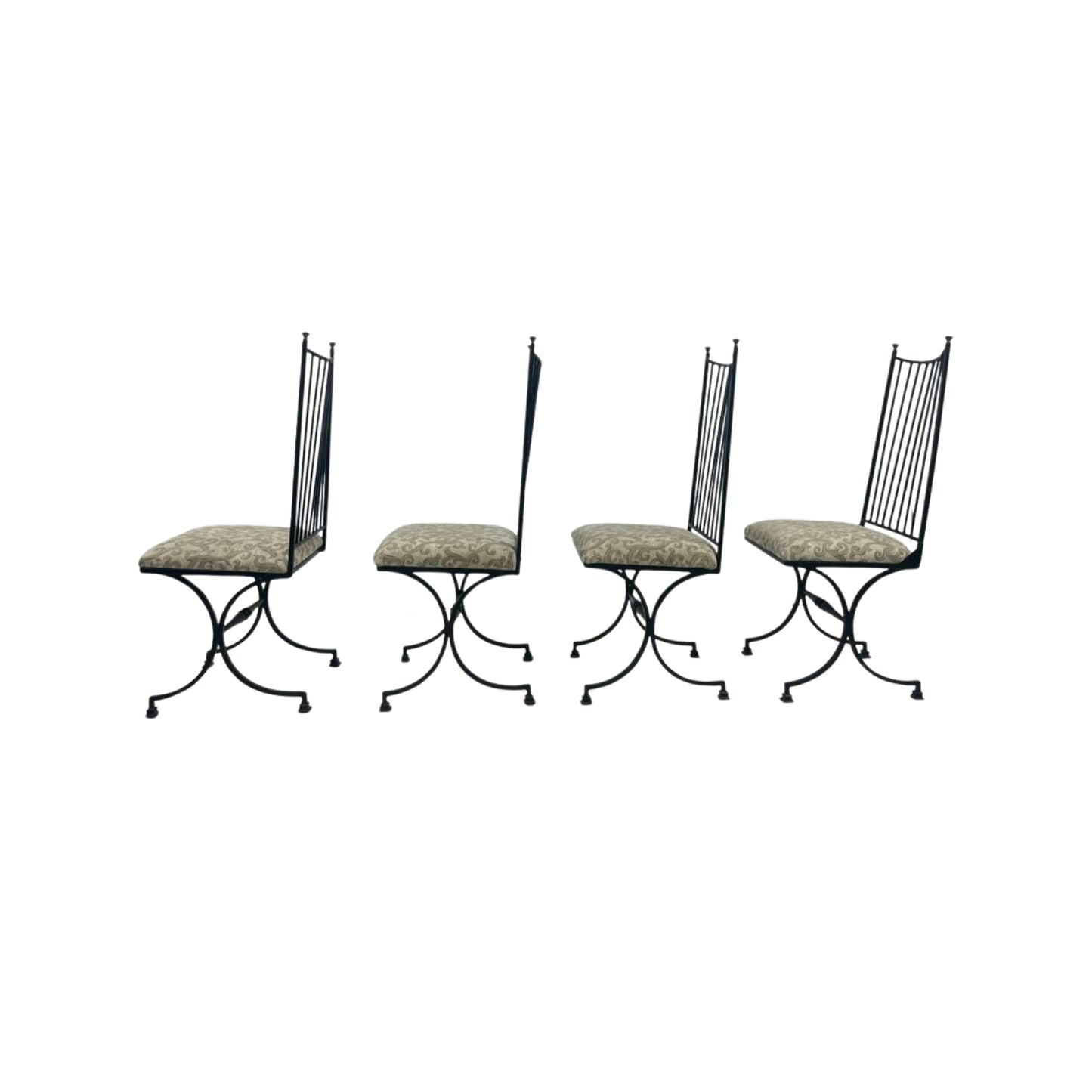 Four black metal chairs with patterned cushions