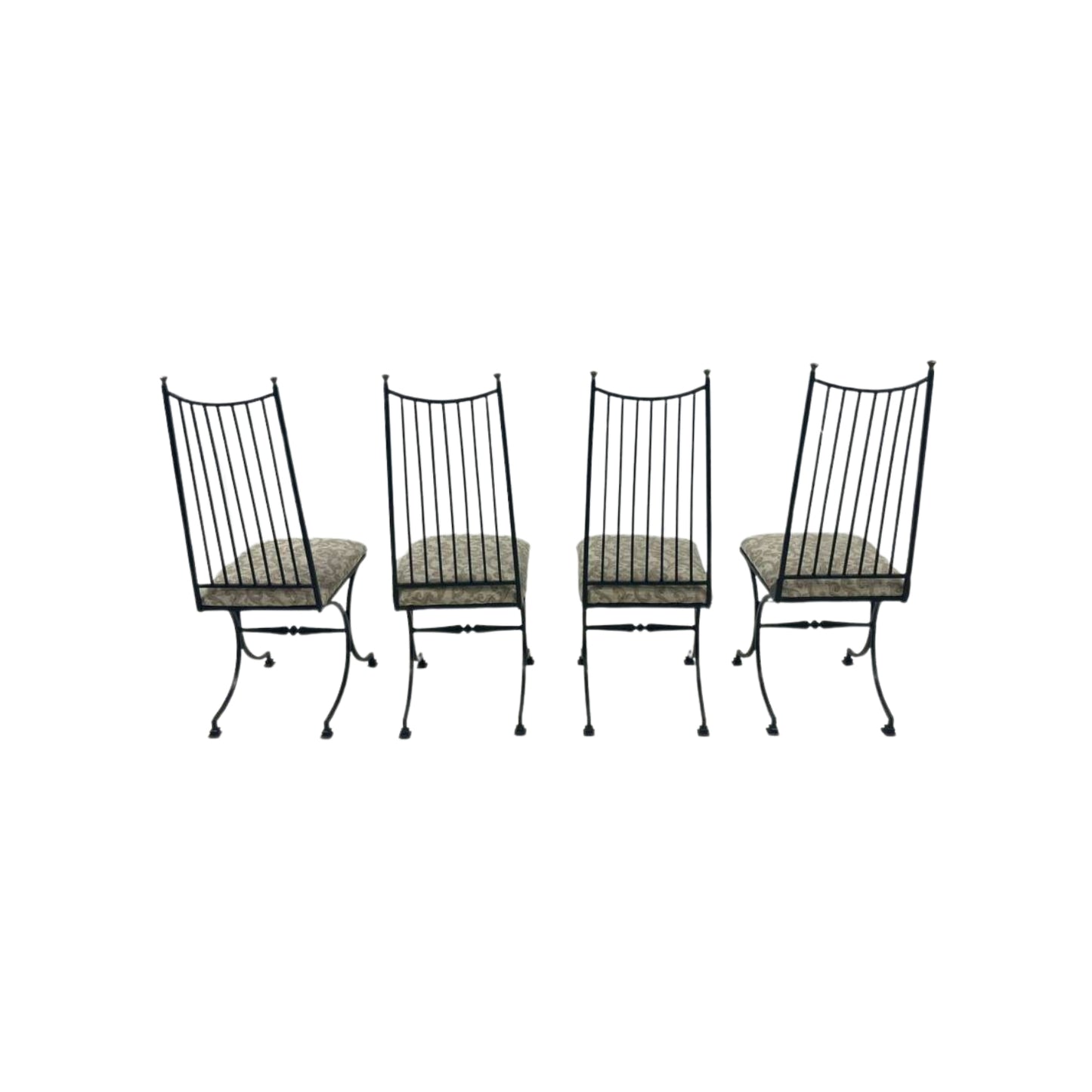 Four black metal chairs with patterned cushions
