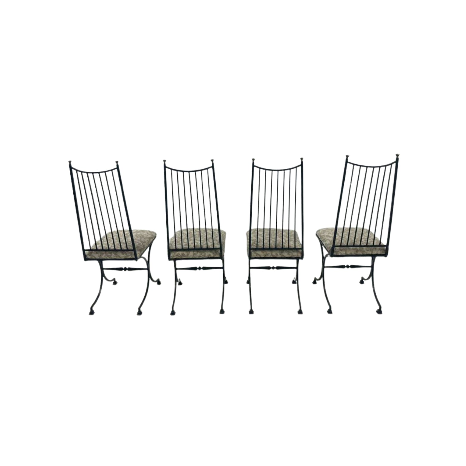Four black metal chairs with patterned cushions