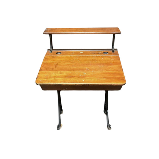 Front view of a vintage wooden child school desk