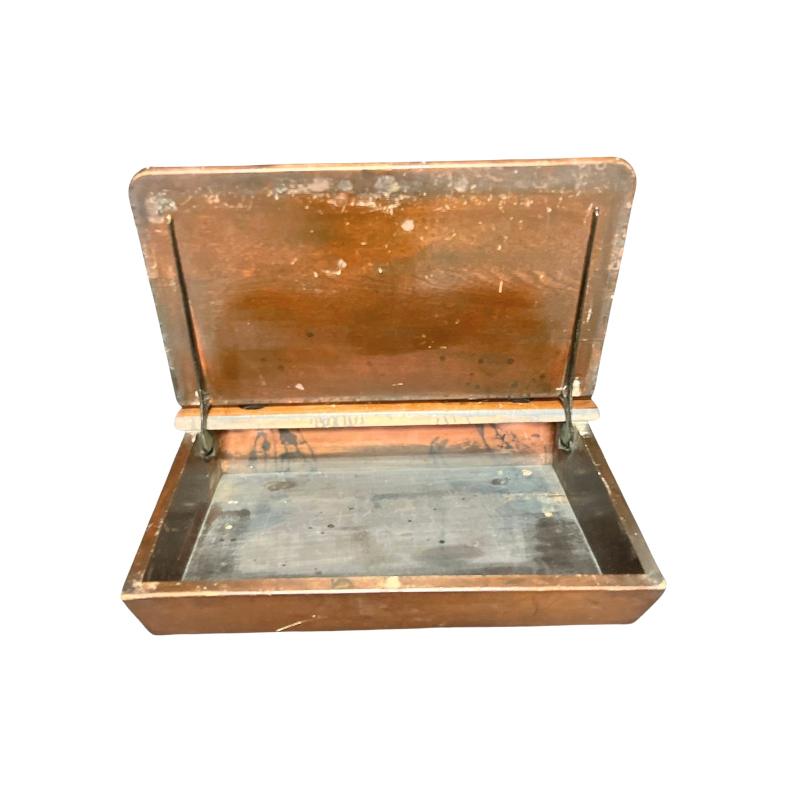 View of the inside of a vintage wooden child school desk drawer