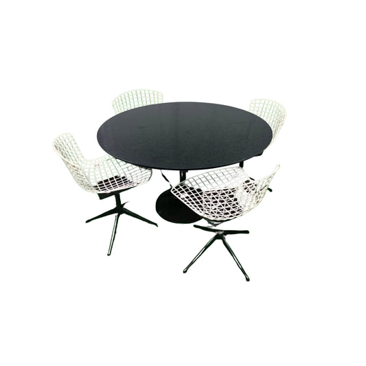 Round black granite table with 4 white wrought iron chairs on a white background