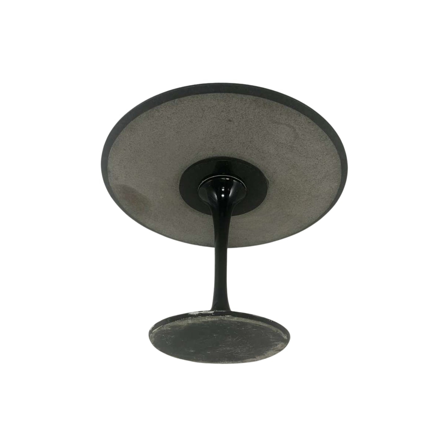 Bottom view of a black round granite table on a white background