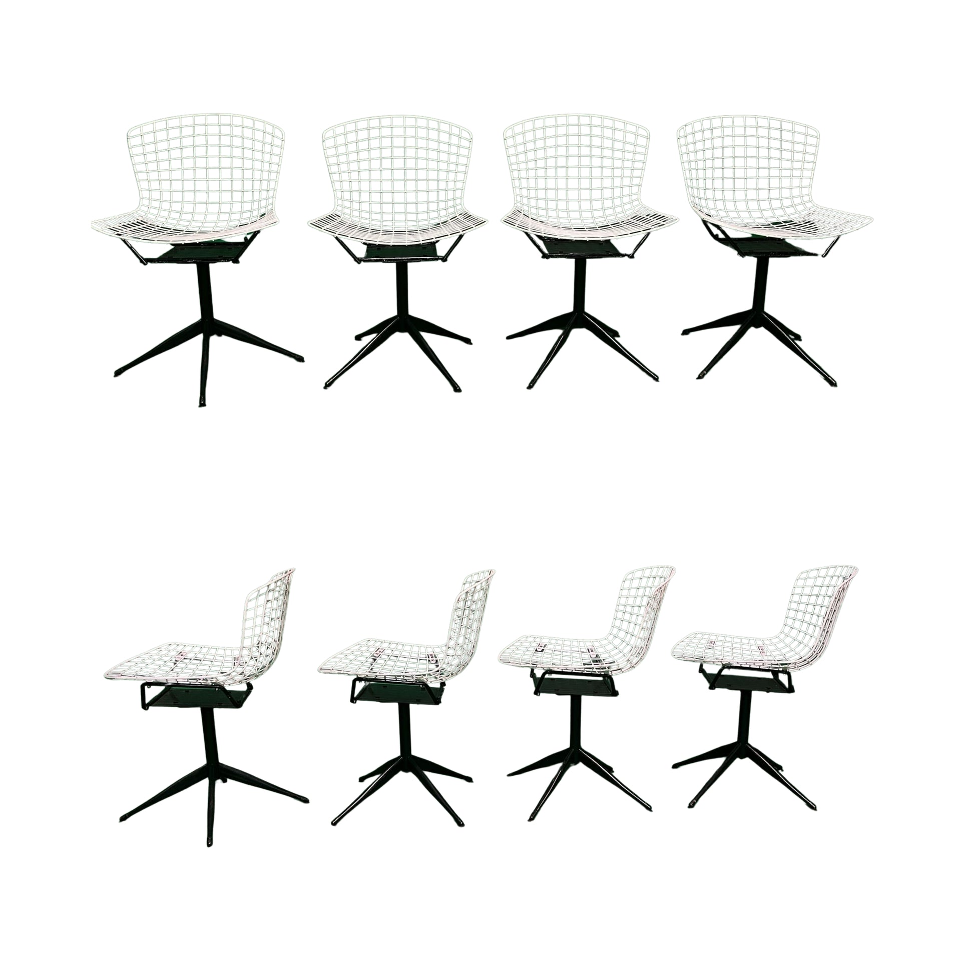 Front and side view of 4 white wrought iron chairs on a white background
