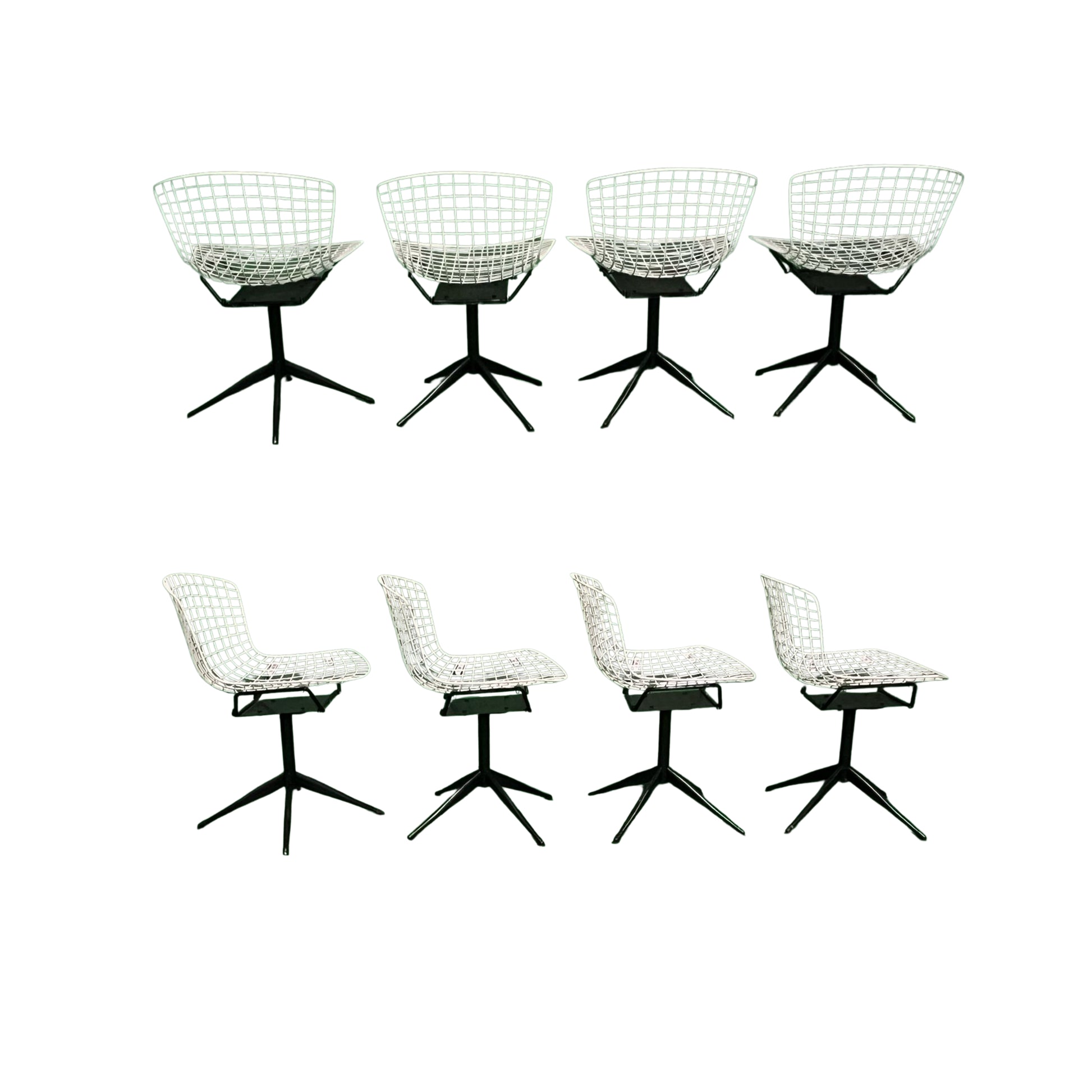 Back and side view of 4 white wrought iron chairs on a white background