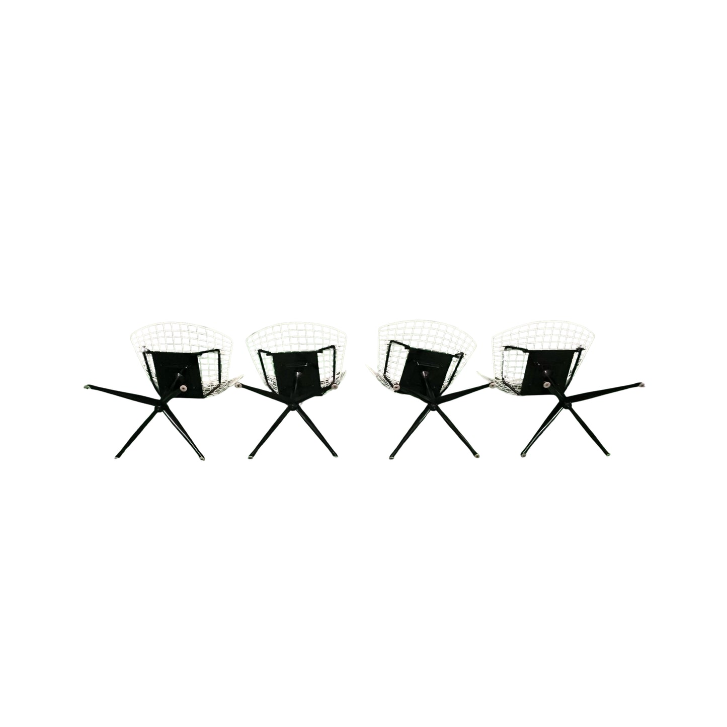 Bottom view of 4 white wrought iron chairs on a white background