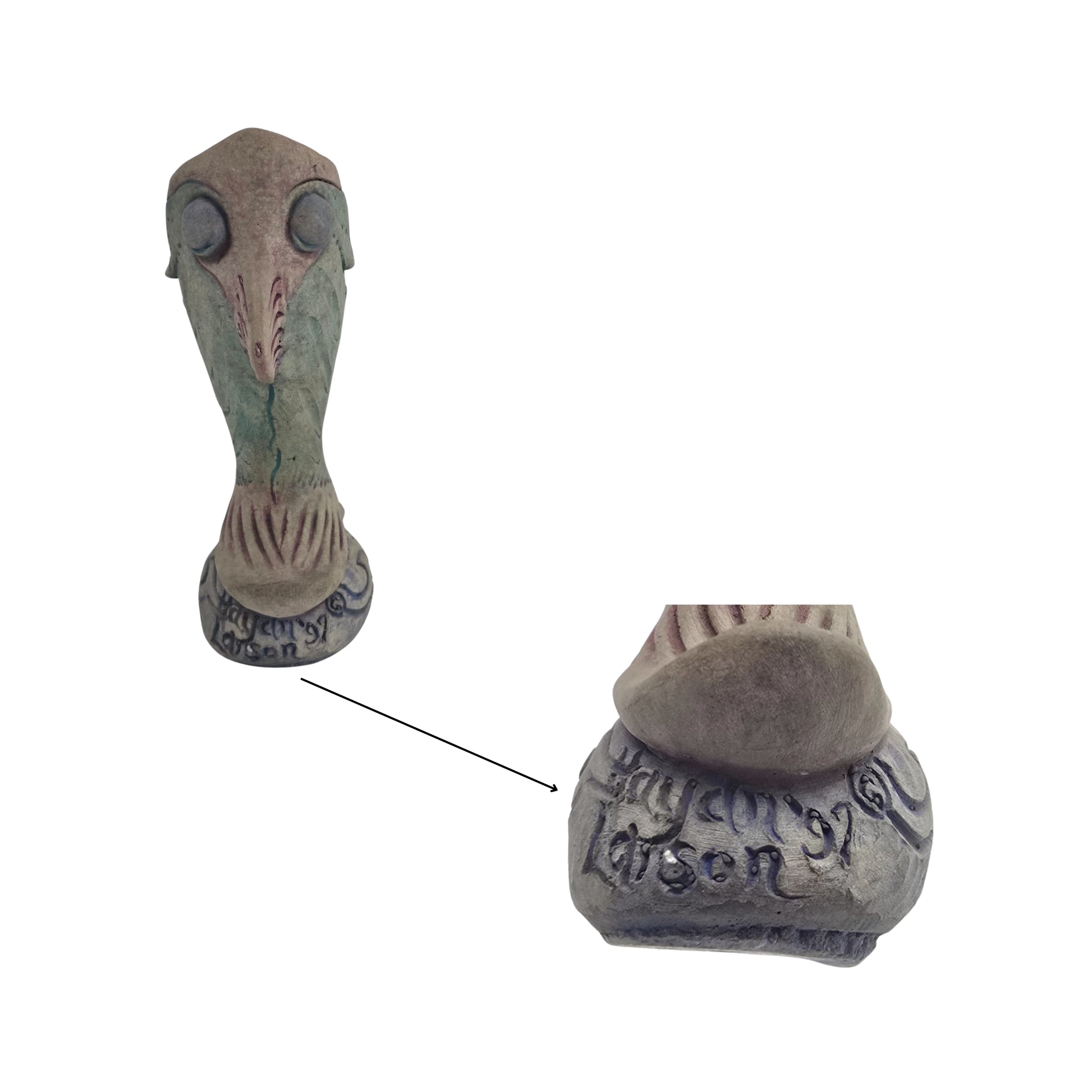 Detail view of a writing that has the decorative vase shaped like a fish on a white background